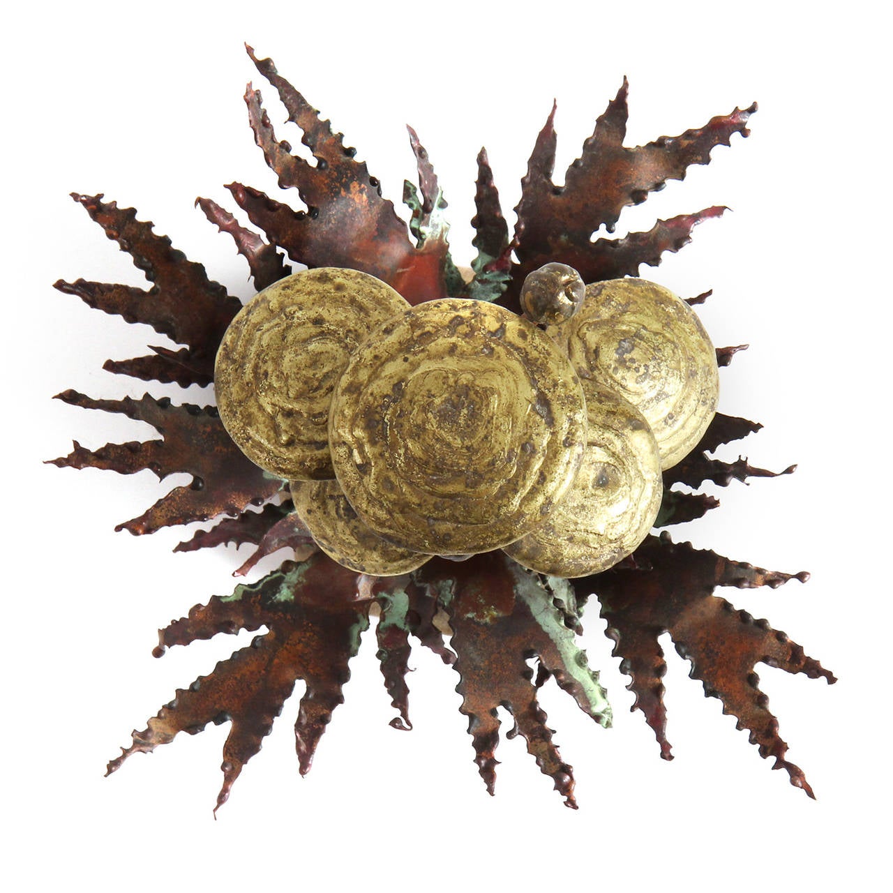 A beautiful and unique hand made metal sculpture depicting mushrooms and dandelion leaves sprouting from a stone base and having a rich variegated patina.