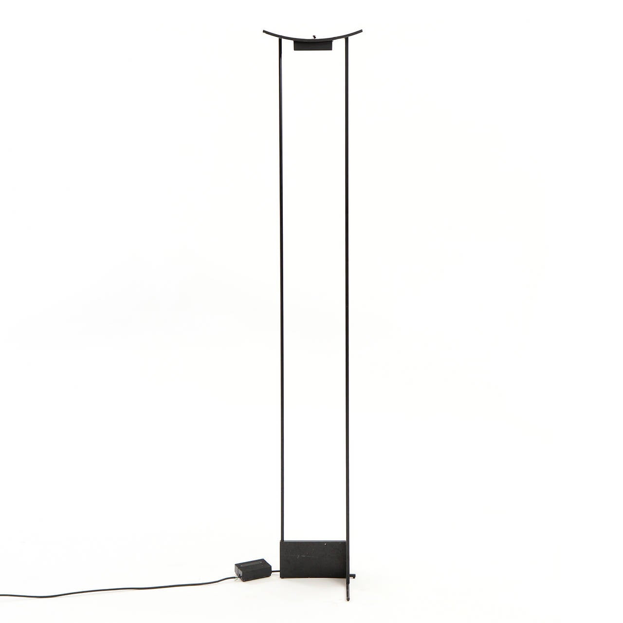 A minimalist, architectural and refined torchiere having a matte black rectilinear frame topped by an expressive subtly arching element housing the light source.