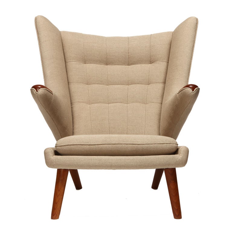 A reupholstered vintage papa bear wing-back armchair with exposed arms and tapered dowel legs. Design by Hans J Wegner made by A.P. Stolen.

Chair in image is a representation. Chairs will be refinished to identical quality. COM required, but must