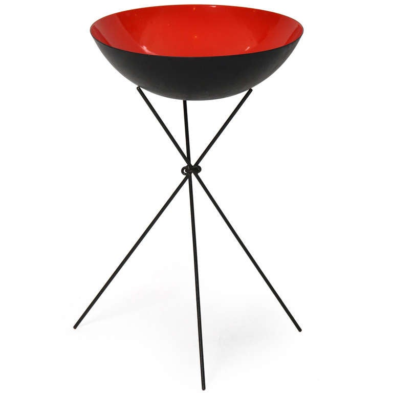 A large-sized bowl or planter in steel and red porcelain enamel with its original rare minimalist stand fashioned from three blackened rods of iron.