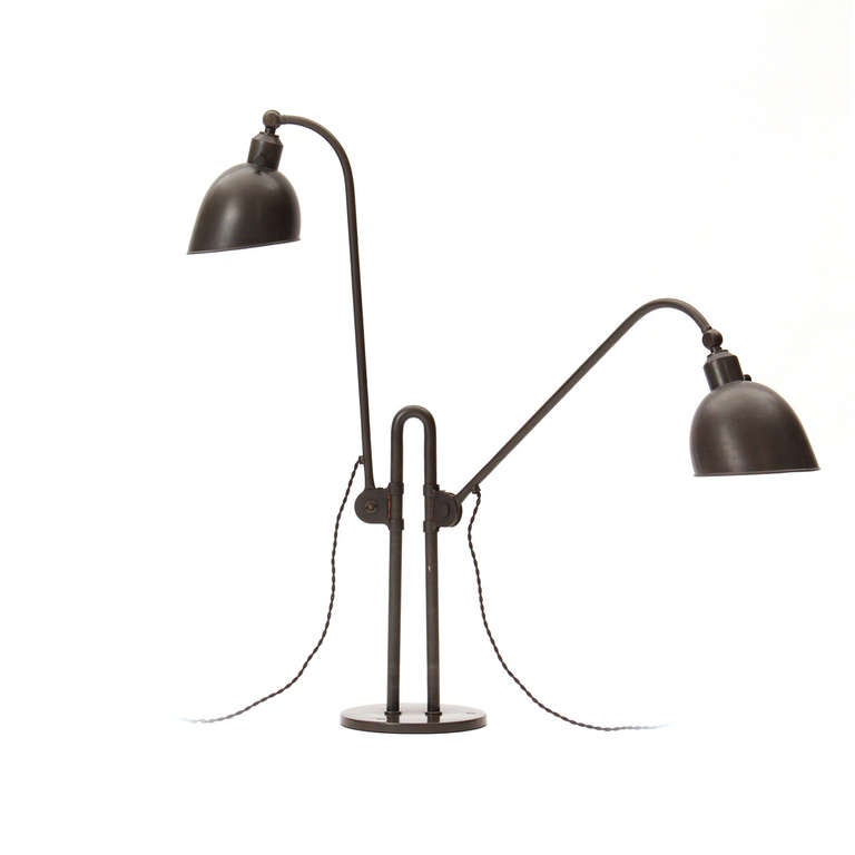 A rare and early articulated double lamp from the Bauhaus master in nickel-plated tubular steel and painted metal. Each stem can adjust independently from the central curved stanchion allowing for a myriad of lighting options. This lamp is in fine,