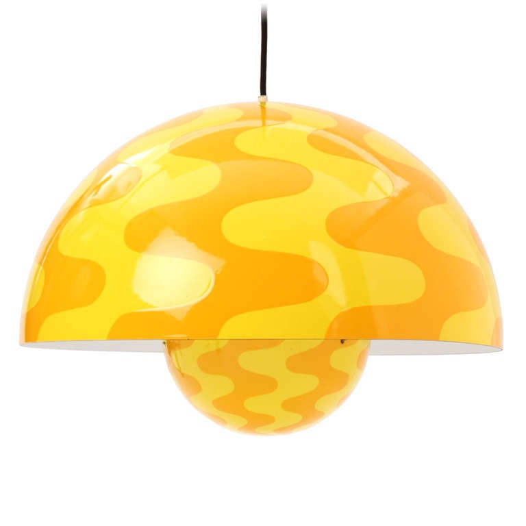 This rare pendant is the largest size that was manufactured and has undulating waves in yellow and orange executed in porcelain-enameled steel.