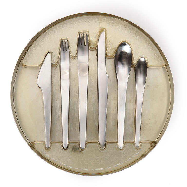 A unique Minimalist set of flatware in stainless steel consisting of six pieces with serving for eight (8), all packaged neatly in a serving tray with a cast resin mold and Plexiglas lid.
Place setting includes: butter knife, salad fork, dinner