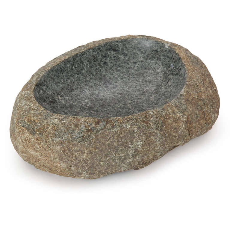 A large granite stone bowl with a perfectly carved, honed, and polished surface.
