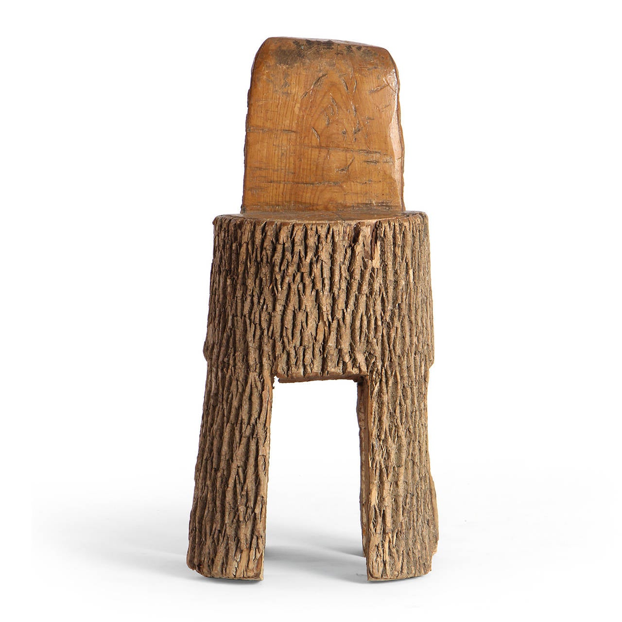 A well scaled and stout chair or stool masterfully hewed and carved from a singular mature oak tree trunk.