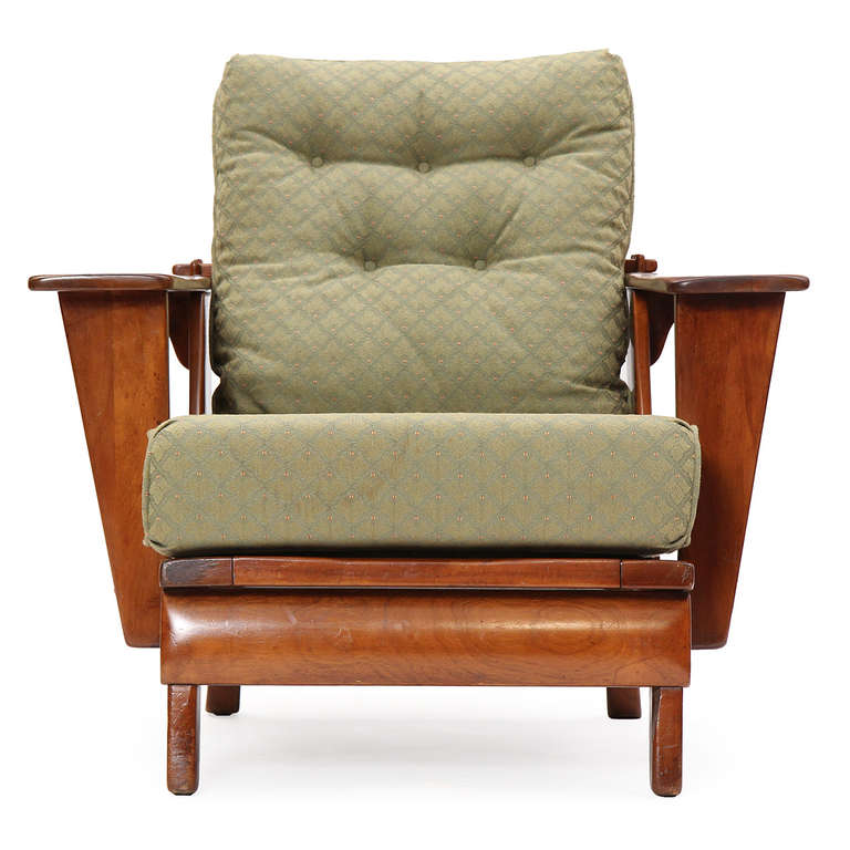 An interesting and well-crafted adjustable reclining armchair with ottoman, having an exposed wooden frame with generous paddle arms and loose seat and back cushions.