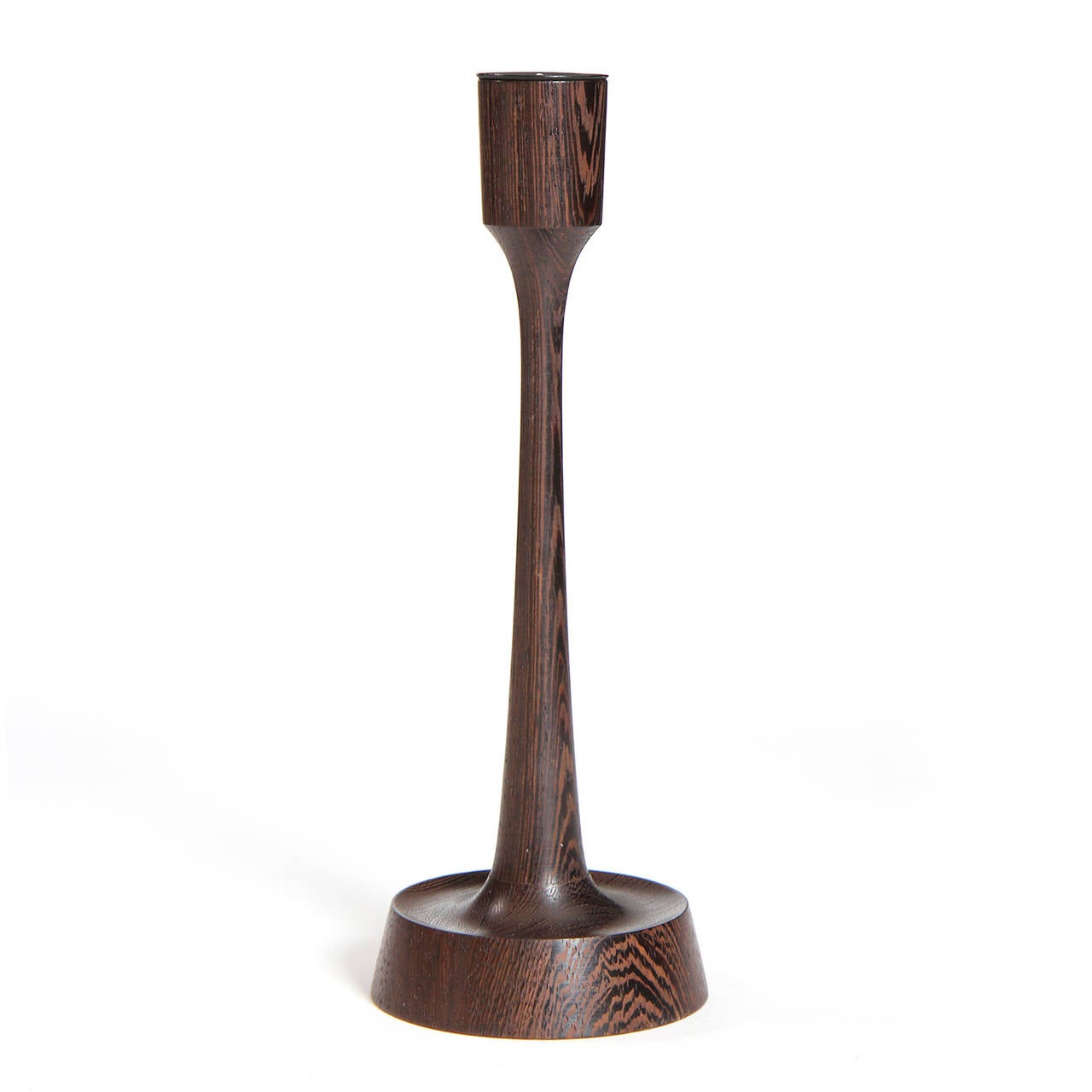 A sculptural and finely turned candle holder made of richly grained wenge.