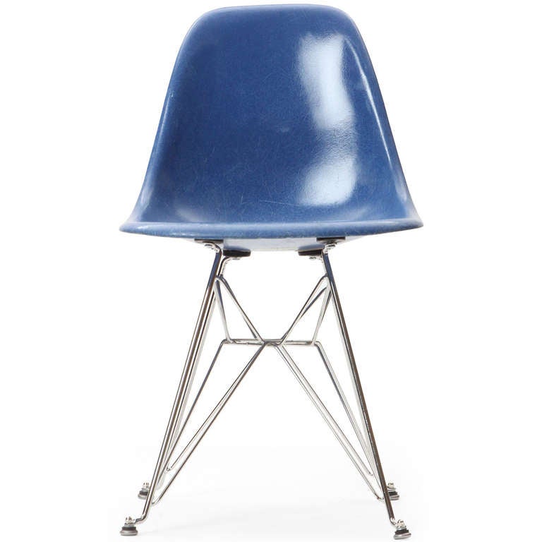 An excellent set of early production side chairs by Charles and Ray Eames in an uncommon blue color having fiberglass seats rising from zinc-plated architectural Eiffel Tower bases.