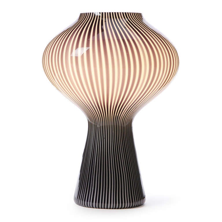 An excellent blown glass table lamp with a translucent lavender linear swirl pattern.