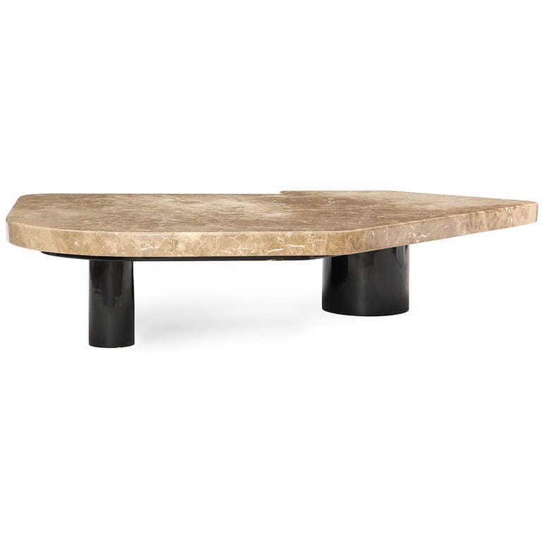 An architectural low table with a steel base with an oval and circular legs supporting a massive top of solid three inch thick marble.