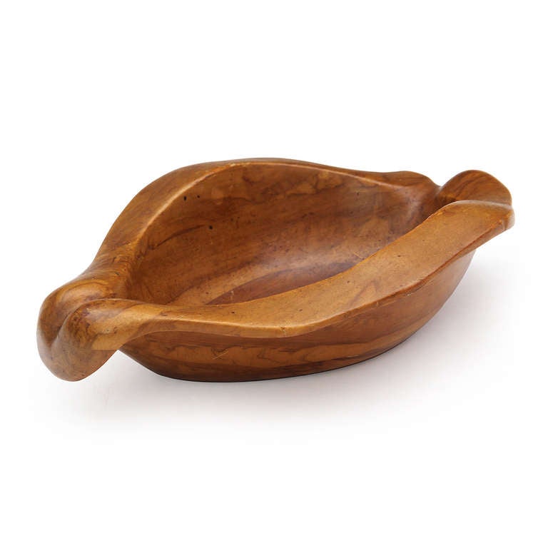 A hand carved biomorphic bowl in claro walnut from the 'Oceana' series. Manufactured by Klise Wood Works in small quantities, with a branded signature. Made in the USA, circa 1930s.