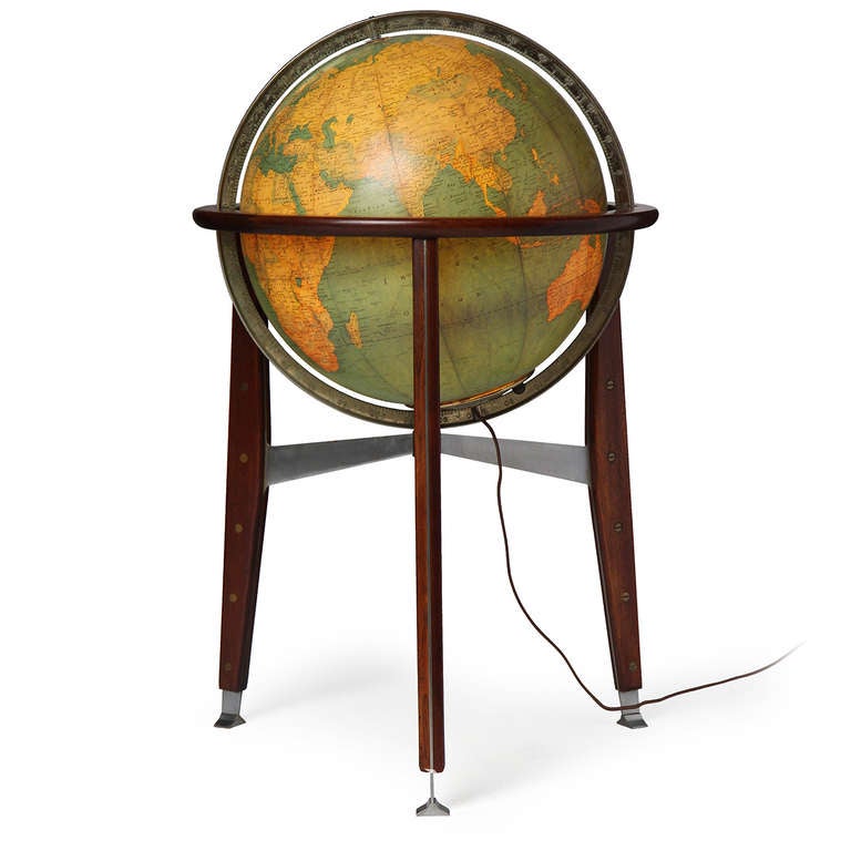 An outstanding glass globe of the earth with a single bulb inside atop a simple walnut tripod stand with riveted steel blades.