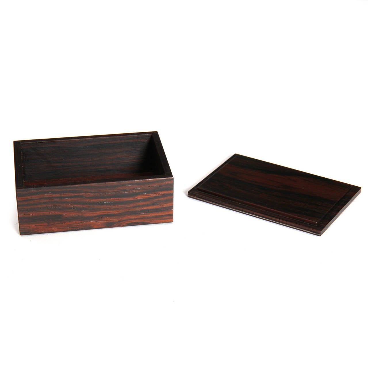 An impeccable and spare hand crafted lidded box made of richly grained Brazilian rosewood.