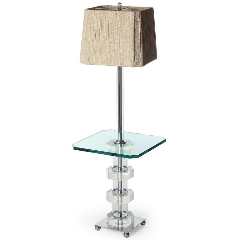 An excellent floor lamp table having faceted Lucite base on metal ball feet, a clipped corner green glass table.