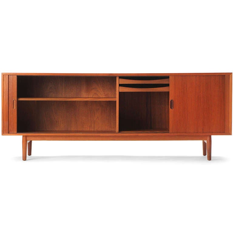 A teak credenza with tambour doors on a low dowel leg base.
