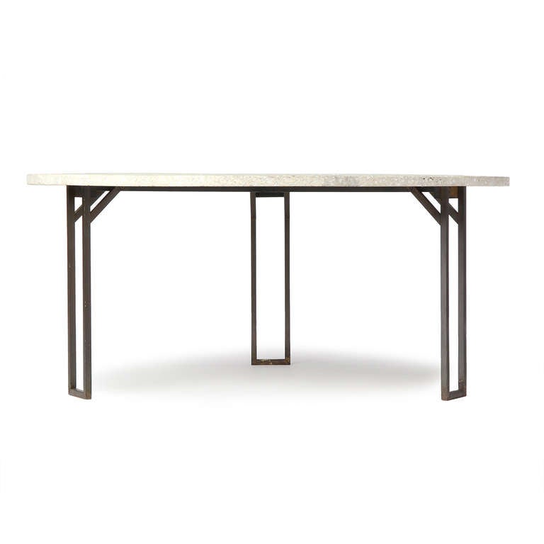 An architectural round low table with a terrazzo top inlaid with bronze atop a three leg bronze base.