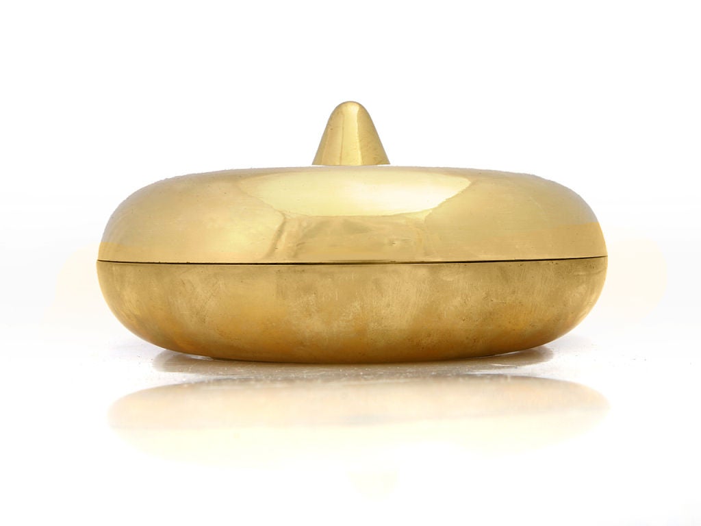 A unique spun-brass two-part ashtray / cachepot in the form of a sphere with a protruding cone. Lid removes easily and the item could easily function as a coin catchall on a vanity or desk