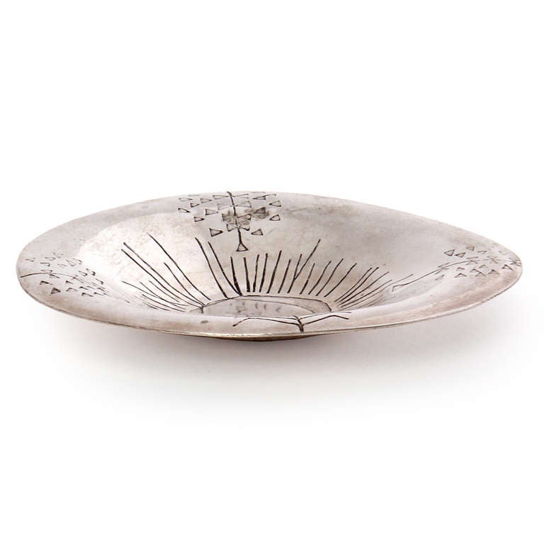 A unique and rare bowl, hand-wrought and hammered with an abstract design of sun and plants. Executed in a hard silver alloy.