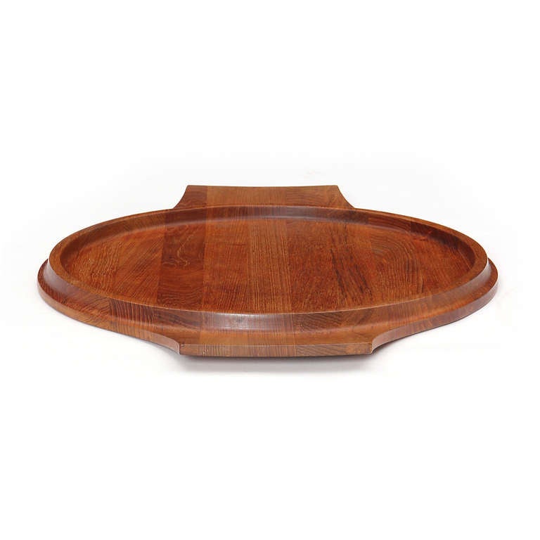 An excellent large teak platter with handles and a circular retaining lip.