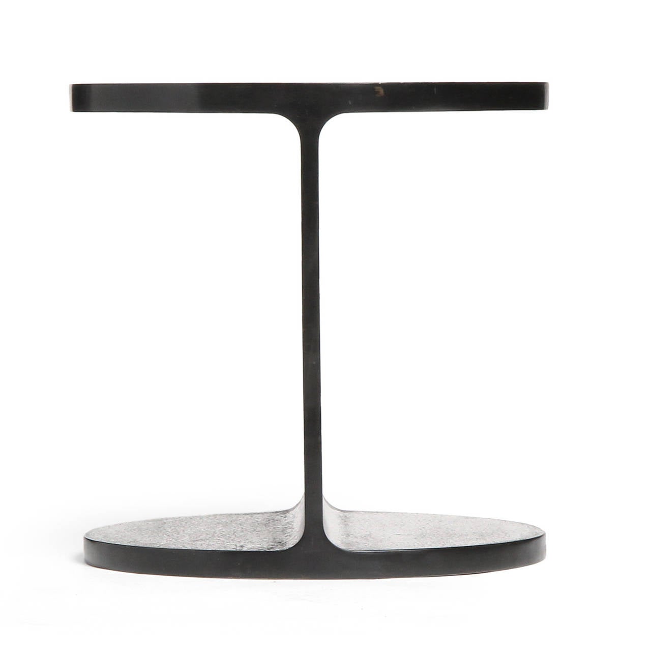 A superbly rendered and sublimely minimalist side table in the form of a perforated truncated I beam. Fashioned of hot rolled and welded steel with a polished natural grain surface, this versatile table can be left bare or topped with glass or stone.