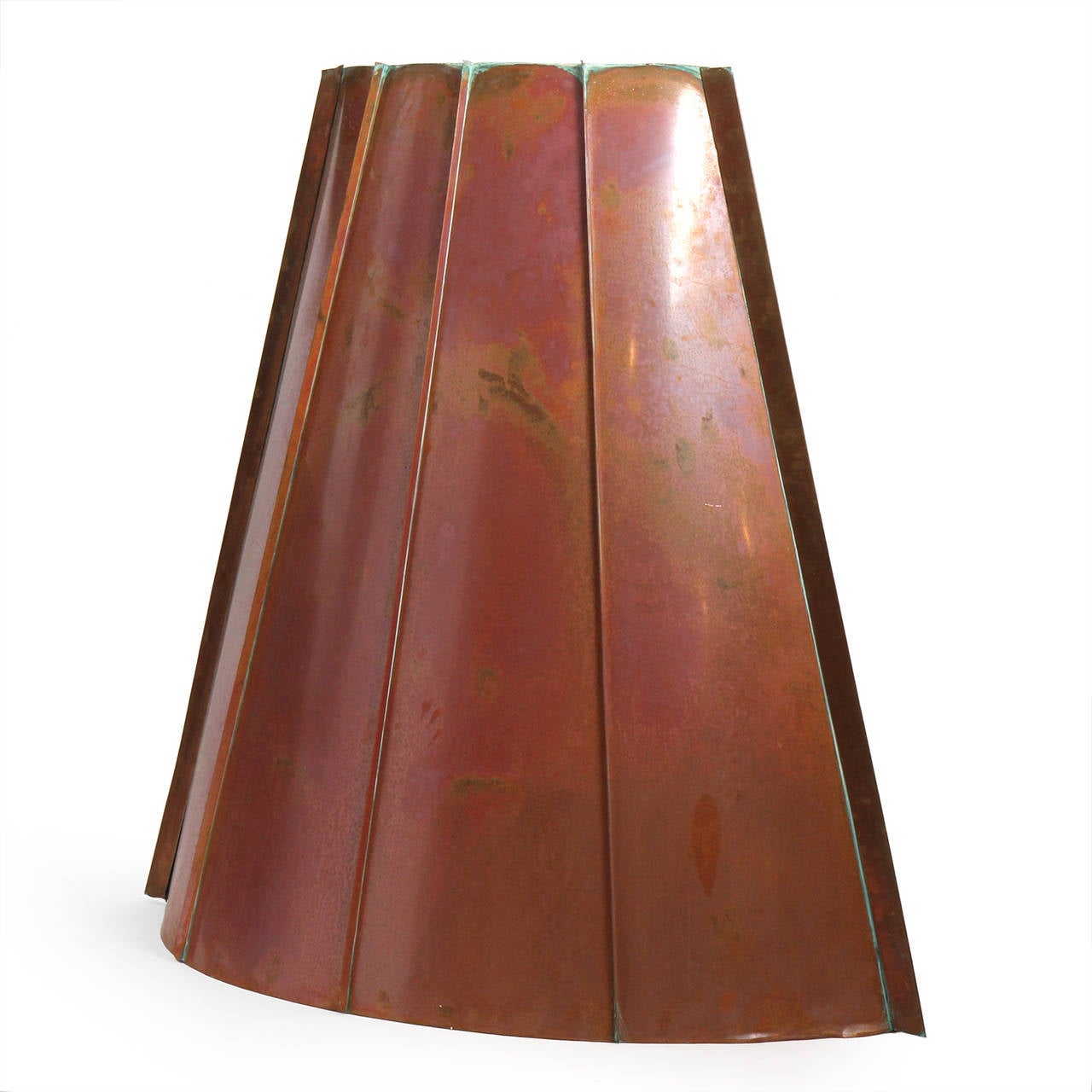A large scaled and beautifully constructed custom copper flue or hood made of standing seam tapered panels having a warm patina.