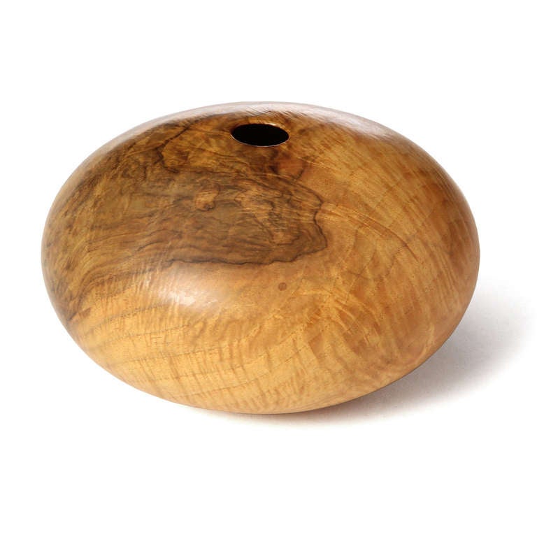 An outstanding turned hollow form vessel, with a squat spherical shape. Signed 'Ellsworth 1981 English Walnut'.