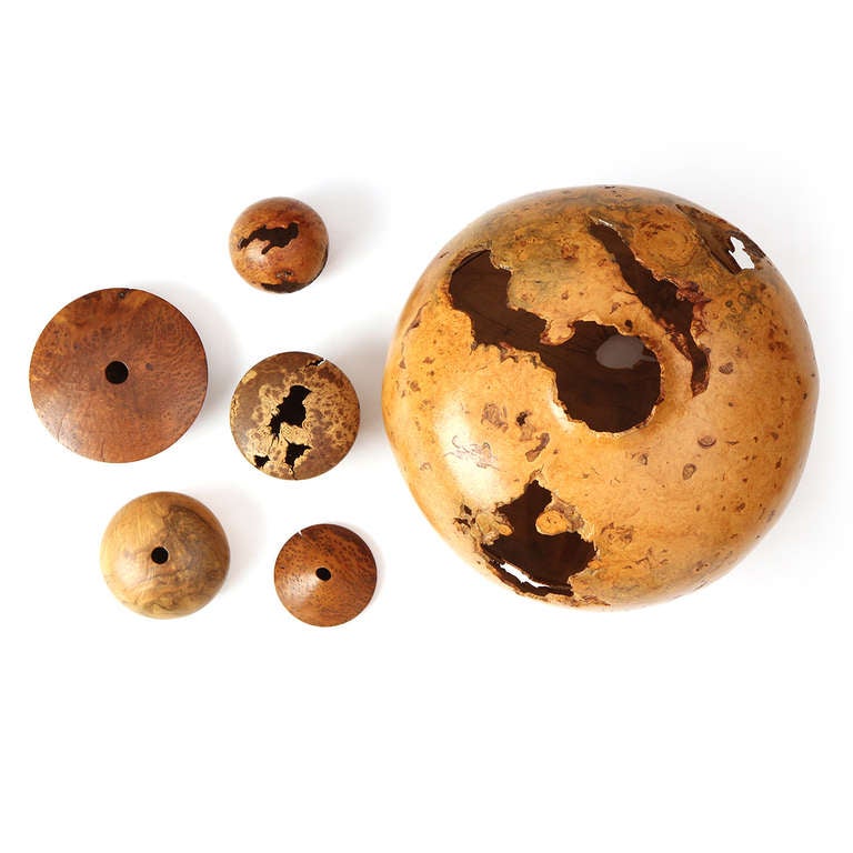 An exceptional and impressive large turned globe of Norwegian Burl Maple, only 4mm thin with natural openings and an incredible seam of hand stitched woven leather. Signed and marked by maker.