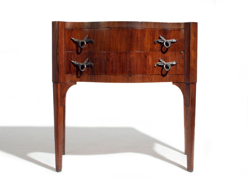 A Venetian style rosewood commode with a flush-edged top, locking drawers and hand-chased antiqued brass pulls.  Designed by Edward Wormley made by Dunbar.