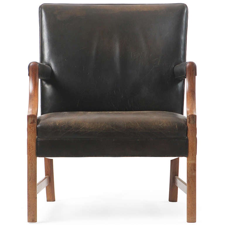 A modern Chippendale-influenced armchair crafted in mahogany with original black leather upholstery and leather welting.