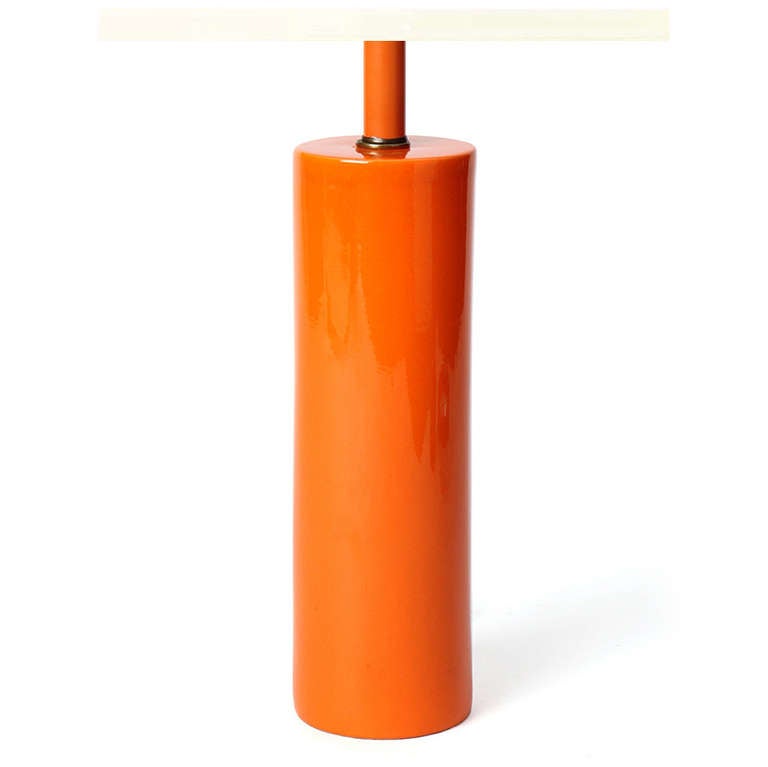 A sublimely simple cylindrical ceramic table lamp with a flawless orange glaze.