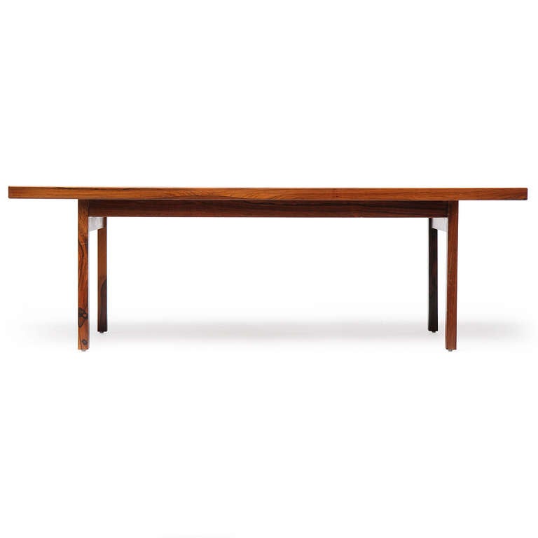 A simple and straightforward rosewood console or tall coffee table with rectilinear form.