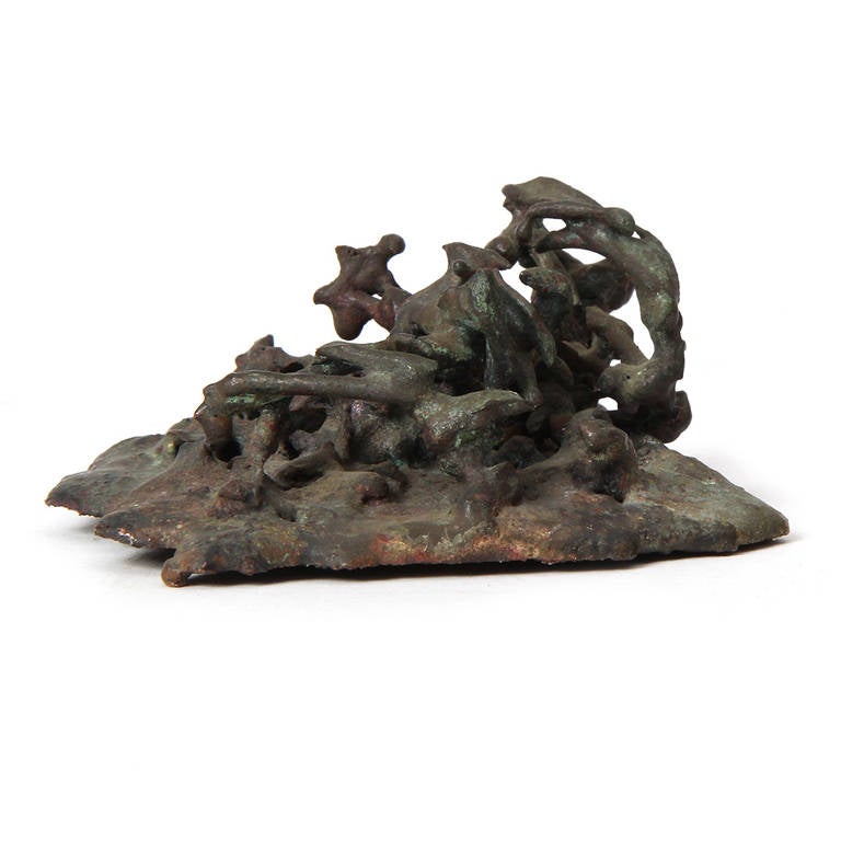 A unique and small sculpture constructed of molten bronze in the manner of ocean floor plant life.