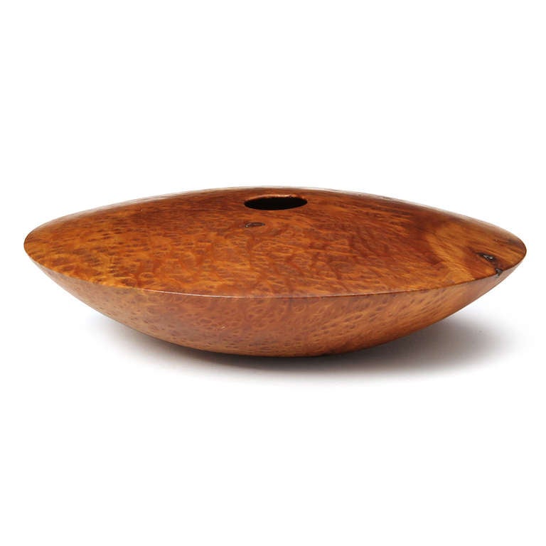 A fine turned hollow form disc-shaped vessel in expressive Redwood burl having an arching flattened top and a shallow shaped bottom. Signed 