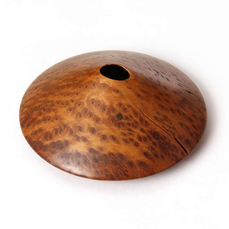 A delicate turned vessel in Redwood burl with a flattened bottom and cone shaped upper. Signed 