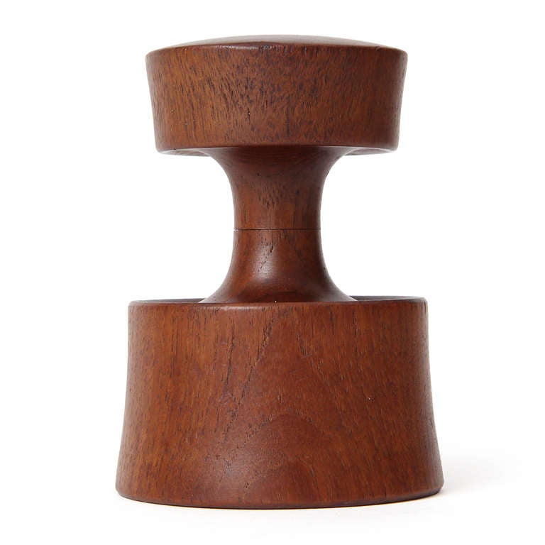 An elegant and simple teak pepper mill of an uneven hourglass shape; with Peugeot Frères steel grinder. Also stamped 