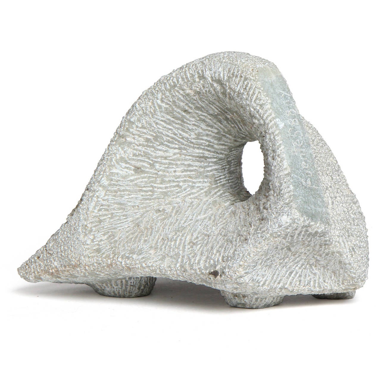 An expressive and finely crafted sculpture having a pierced abstracted form, made of carved and etched grey marble.