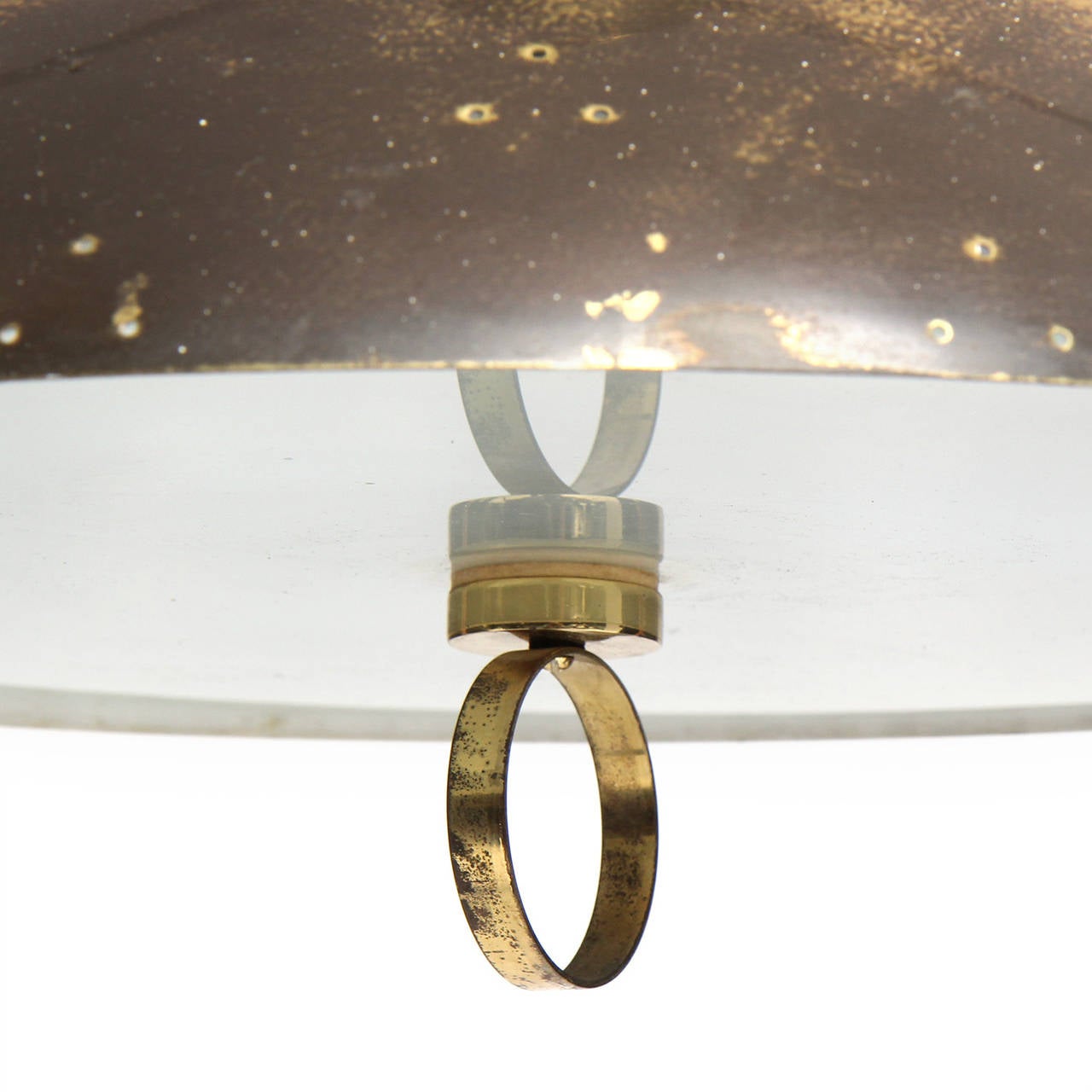 An adjustable patinated brass pendant having as shapely perforated shade and frosted glass diffuser with a brass ring pull. Recoiled cable is concealed in the canopy.