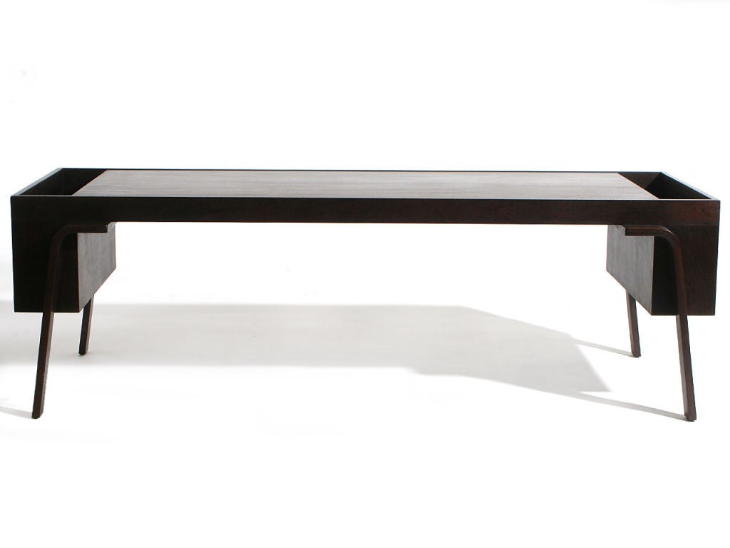 An ebonized mahogany low table with magazine boxes on the ends.