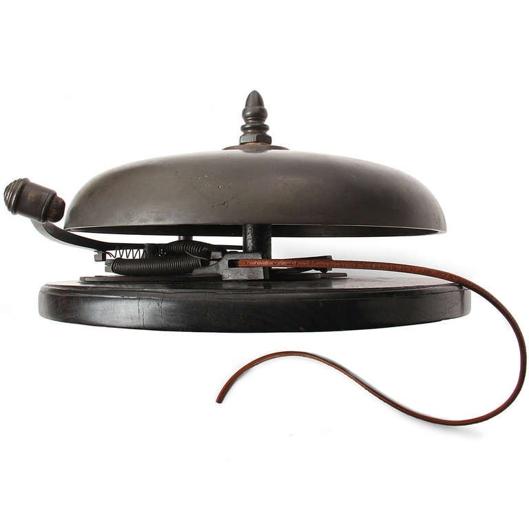 A large, finely fabricated and warmly patinated bronze boxing bell with a leather cord pull, on an ebonised mahogany mount.