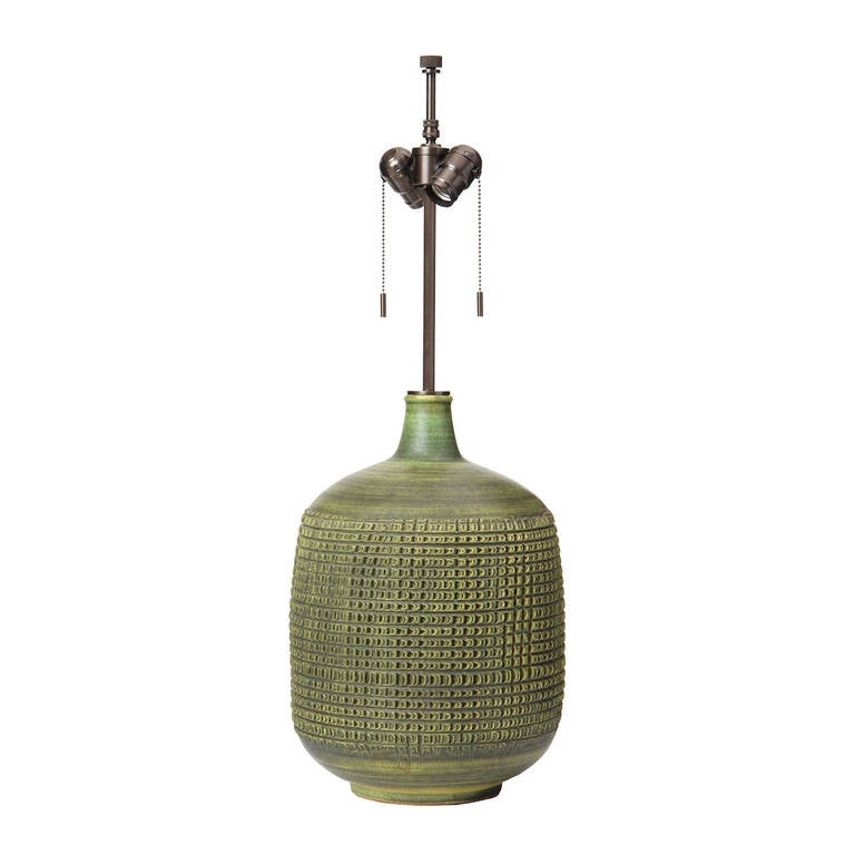 An excellent ceramic table lamp with a hand tooled, woven pattern in a satin green glaze.