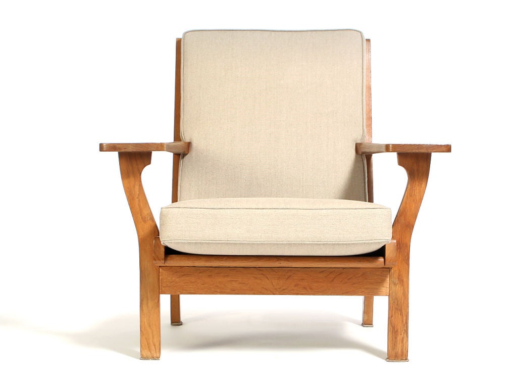 A pair of oak wide arm lounge chairs with Belgium linen upholstered cushions. Produced by Getama.