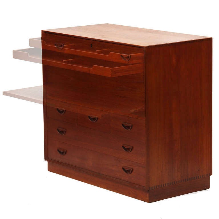 A Scandinavian Modern teak sideboard / dresser unit by Danish designers Peter Hvidt & Orla Mølgaard-Nielsen. Dresser features five drawers with carved recessed pulls on a plinth base, exposed dovetail joinery and a drop down work surface. Produced