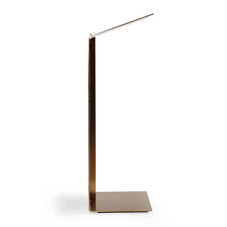 A sublimely simple lectern constructed mostly of a single sheet of bent bronze with a rich golden patina.