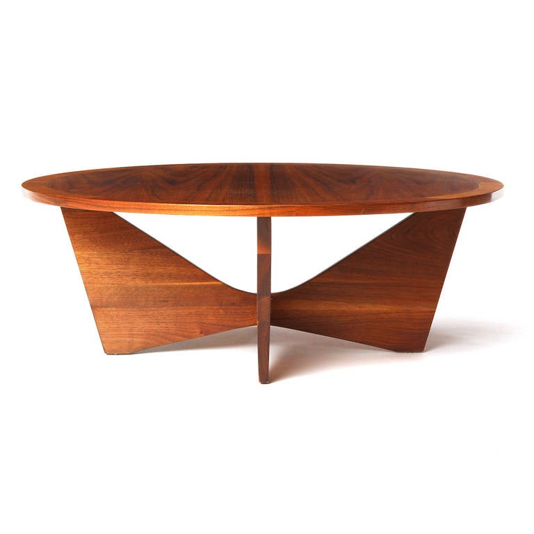 An exquisite and minimalist walnut low table with butterfly-like base and circular top.