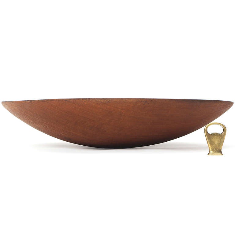An exceptionally large carved and turned low-walled bowl in teak.