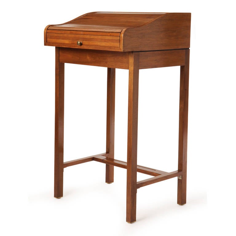 A unique and elegant lectern in walnut with a roll top cover and a single drawer.