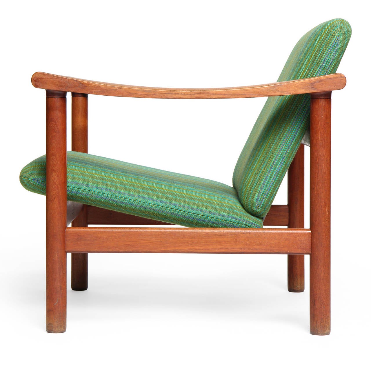 A pair of generously scaled and finely crafted teak lounge chair shaving a sculptural and architectural open frame with flattened arms, supporting a floating upholstered seat.