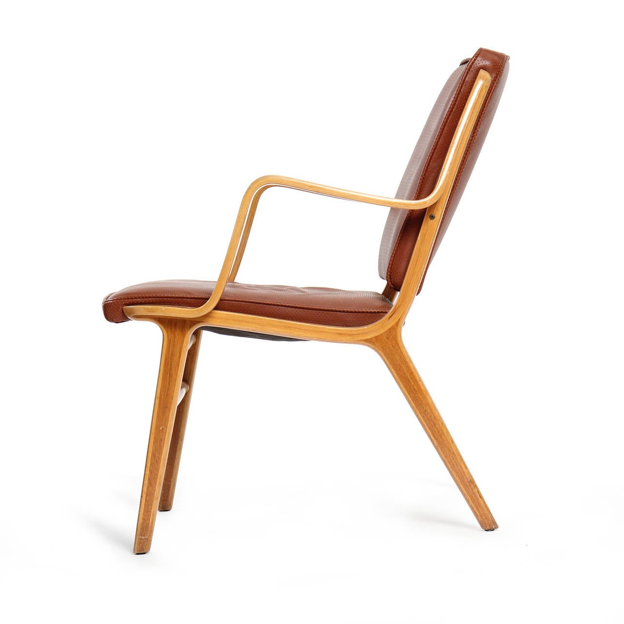 A sculptural and innovative arm chair having frames of laminated teak and beech with an expressive contrasting wood detail.