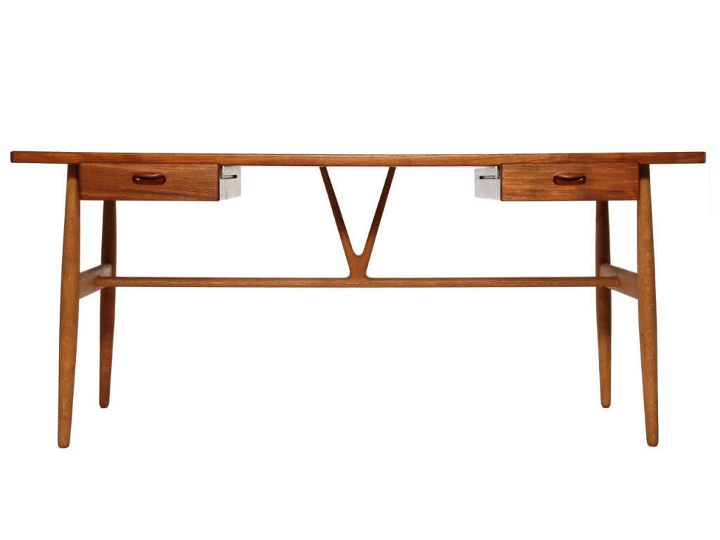A teak and oak desk with two drawers and wishbone detail. Design by Hans Wegner, Cabinetmaker Johannes Hansen