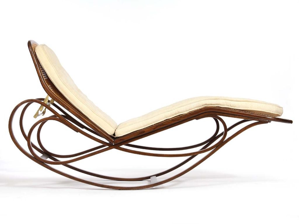 An adjustable rocking chaise with caned seat and back with bent ash frame and upholstered cushion. Design by Edward Wormley for Dunbar